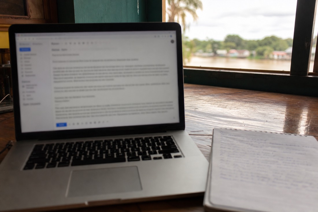 Laptop and handwritten list of questions on a desk, email drafted to a retreat center