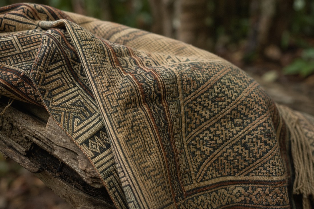 Close-up of a handwoven Amazonian textile with geometric patterns in natural dyes